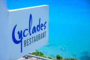 a sign for a restaurant with a view of the ocean at Hotel Perrakis in Kipri