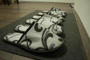 a row of shoes lined up in a row at Alex Lodge in Zrenjanin