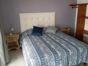 a bedroom with a bed with two pillows on it at Deja Vu 2 in Punta Del Diablo