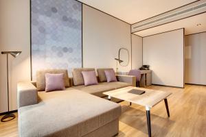 a living room with a couch and a table at Lemon Tree Hotel, Jumeirah Dubai in Dubai
