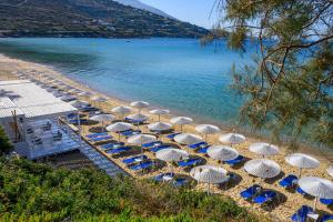 a group of umbrellas and chairs on a beach at Hotel Perrakis in Kipri