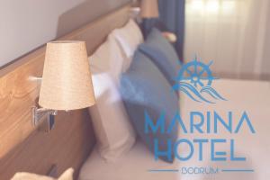 A bed or beds in a room at Marina Hotel Bodrum
