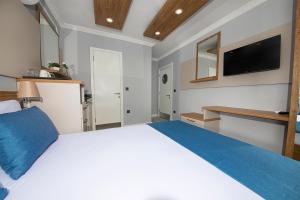 A bed or beds in a room at Marina Hotel Bodrum