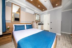 A bed or beds in a room at Marina Hotel Bodrum