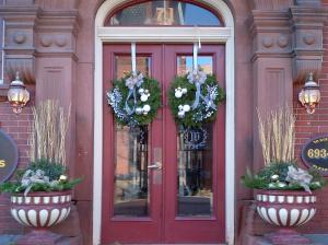 a red door of a building with wreaths on it at Chipman Hill Suites - Sydney Street in Saint John