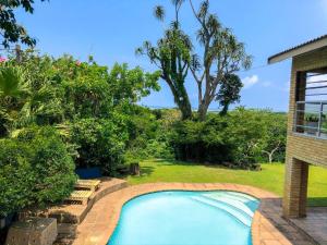 a swimming pool in the backyard of a house at Ingwenya Lodge in St Lucia