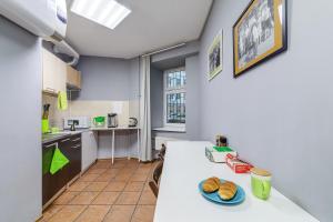 a kitchen with a table with a plate of bread on it at CHEERS Arbat in Moscow