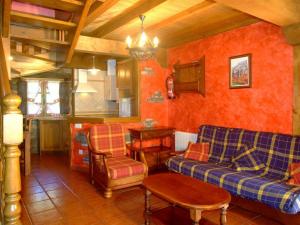 a living room with a couch and a table at Las Casucas de Ason in Arredondo