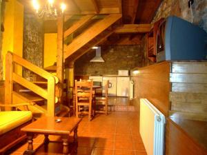 a kitchen with a table and a dining room at Las Casucas de Ason in Arredondo