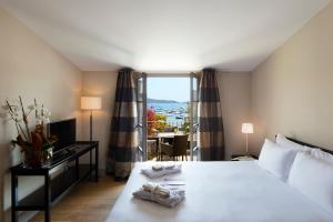 a hotel room with a bed and a window at Le Pinarello in Sainte-Lucie de Porto-Vecchio