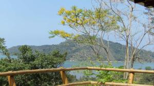 a view of a lake from a wooden railing at Pousada Alto do Tiê in Paraty