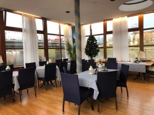 a restaurant with tables and chairs and a christmas tree at The Boat - Hostel&Chill in Kraków