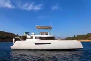 a white boat sitting in the water at Le Pinarello in Sainte-Lucie de Porto-Vecchio