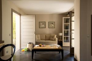 a living room with a couch and a table at Le Pinarello in Sainte-Lucie de Porto-Vecchio