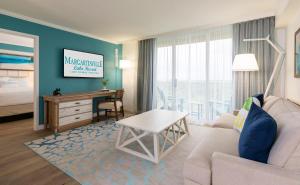 a living room with a couch and a table and a bedroom at Margaritaville Lake Resort, Lake Conroe in Montgomery