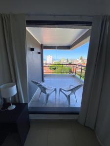 
a room with a bed and a window at Hotel Montecarlo in Mar del Plata

