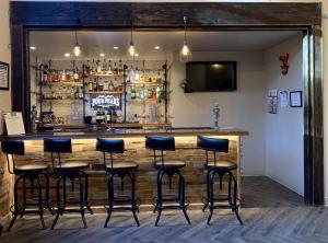 a bar with stools in front of a counter at GreenTree Inn & Suites Pinetop in Pinetop-Lakeside