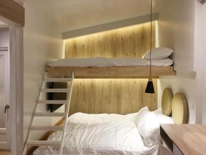 a bedroom with two bunk beds and a ladder at The Goose House Ubon in Ban Na Khwai