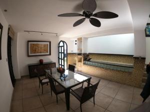 a dining room with a ceiling fan and a table at The Latit Hotel Querétaro in Querétaro