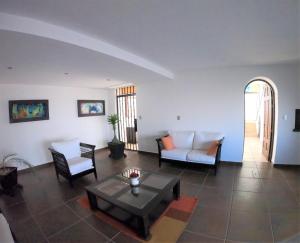 a living room with a couch and a table at The Latit Hotel Querétaro in Querétaro