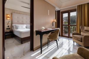 a hotel room with a bed and a desk and a bedroom at Santa Catalina, a Royal Hideaway Hotel in Las Palmas de Gran Canaria