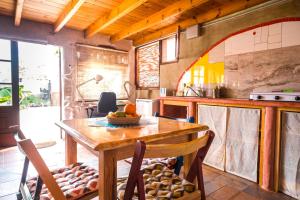 a kitchen with a wooden table and chairs at Casa Inspirada in Los Estancos