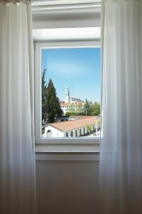 a window with a view of a building at Hotel Santa Maria in Fátima