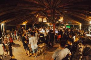 a crowd of people standing in a room at Kadir's Top Tree Houses in Olympos