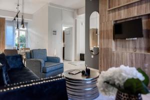 a living room with a blue couch and a table at ''SteliosDimitra'' Guest House II in Nafplio in Nafplio