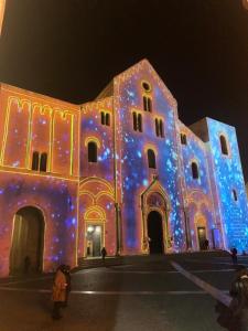un grand bâtiment avec des lumières allumées la nuit dans l'établissement Sister residence rooms, à Bari