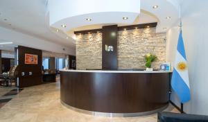 a lobby with a reception desk in a building at Urquiza Apart Hotel & Suites in Rosario