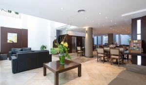 a living room with a couch and a table at Urquiza Apart Hotel & Suites in Rosario