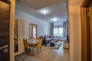 a living room with a table and a couch at Apartman Rada in Zlatibor