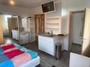 a kitchen with a bed and a sink in a room at Ferienwohnung Kaiserpanorama in Krumpendorf am Wörthersee +15 photos