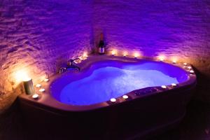 a jacuzzi tub with lights in a brick wall at SPA Apartment Nalis in Niš
