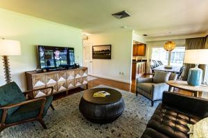 a living room with a couch and a tv at Arnold Palmer's Bay Hill Club & Lodge in Orlando