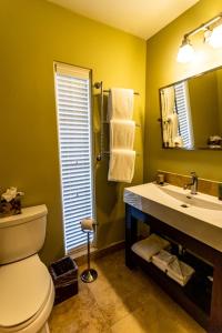 a bathroom with a toilet and a sink and a mirror at Arnold Palmer's Bay Hill Club & Lodge in Orlando
