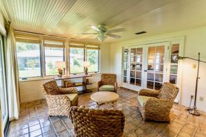 a living room with chairs and a ceiling fan at Arnold Palmer's Bay Hill Club & Lodge in Orlando