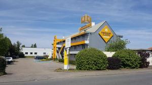 a building with a large sign on the side of it at Premiere Classe Metz Sud Jouy Aux Arches in Jouy-aux-Arches