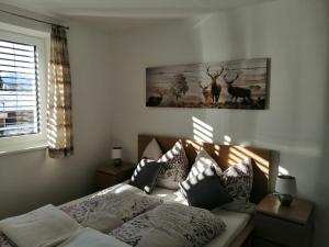 a bedroom with a bed and a picture of deer at Apartment Peotta in Volders