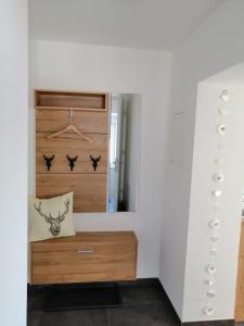 a dressing room with a mirror and a wooden dresser at Apartment Peotta in Volders