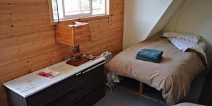 a bedroom with a bed with a desk and a window at Yellow Dog Lodge, Inc. in Yellowknife