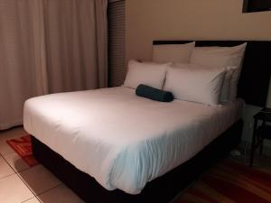 a bed with a black bag sitting on top of it at Whale Rock in Margate +12 photos