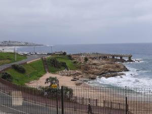 a view of a beach with a pier and the ocean at Whale Rock in Margate