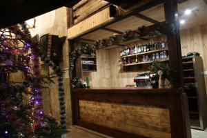 a bar with christmas decorations and a christmas tree at Cheremosh in Yablunytsya