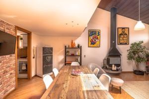 a dining room with a wooden table and a fireplace at Loft 60 - EXCLUSIVE LOFT ROME CITY CENTER in Rome