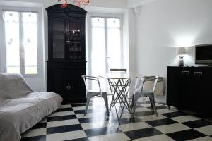 a living room with a table and chairs and a couch at Maison Julien 3 in Menton