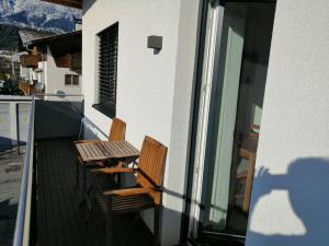 a balcony with two chairs and a table at Apartment Peotta in Volders