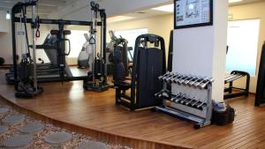 a gym with a bunch of exercise equipment on a wooden floor at Holiday Inn - Villahermosa Aeropuerto, an IHG Hotel in Villahermosa