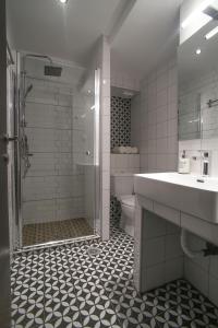 a bathroom with a shower and a sink and a toilet at ZH Luxury Suites in Thessaloniki